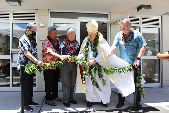 Photo of the Kahului Lani maile lei untying is courtesy of Becker Communications/Catholic Charities Hawaii. Pictured are (from left) Gary Furuta (owner of GSF LLC, development partner); Michael Magaoay (president, CCHDC); Gov. David Ige; Bishop Larry Silva; and Catholic Charities Hawaii president/CEO Robert Van Tassell.
